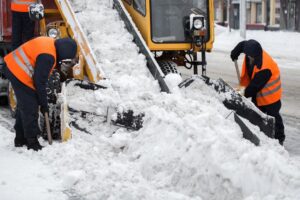 Claw loader vehicle removes snow from the road