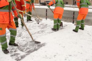 Cleaning workers shoveling snow